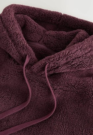 Burgundy bolyhos kapucnis pulóver, puha, texturált anyaggal, állítható zsinórral és kényelmes kapucnival.