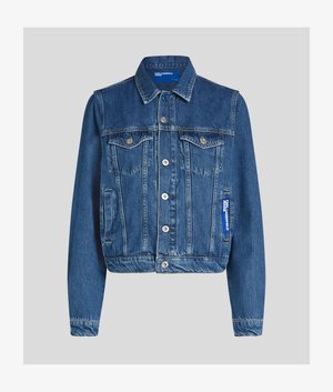 Blue denim jacket with button front, two chest flap pockets with buttons, side pockets, and a small blue label on the right side.