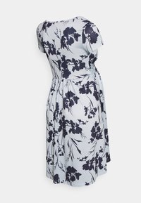 Vestido floral em tecido azul claro com padrões de flores azul marinho, mangas curtas, decote redondo e cintura ajustada, fluindo até ao comprimento dos joelhos.