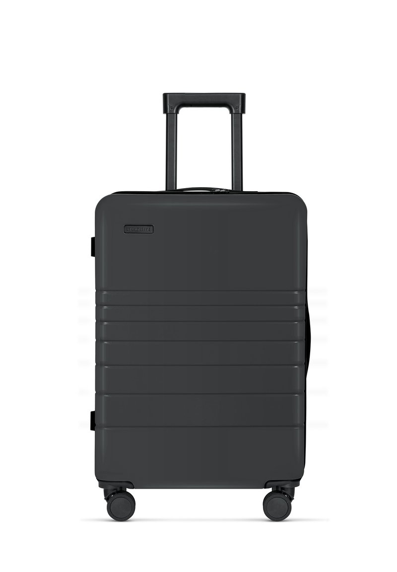 Schwarzer Hartschalenkoffer mit vertikalen Rillen, ausziehbarem Griff und vier Rädern für einfache Mobilität. Kompaktes Design mit Reißverschluss.