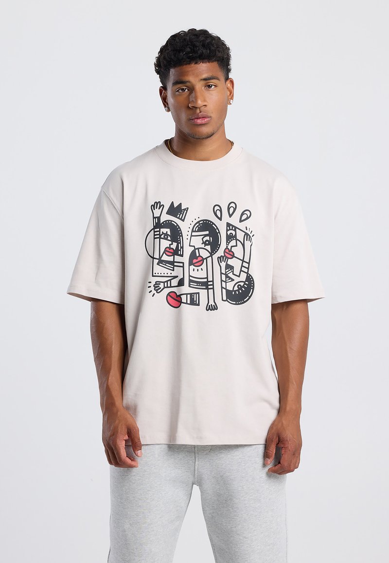 Light beige oversized t-shirt made of cotton, featuring a bold black and red graphic design with abstract human figures and elements.