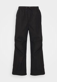 Pantalones amplios, negros y ligeros con cintura elástica y cordón. Textura suave sin estampados ni detalles de hardware.