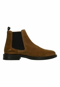 Bruine suede Chelsea-boot met elastische zijpanelen, vlakke zwarte zool en een kleine trekband aan de hiel voor eenvoudig aan- en uittrekken.