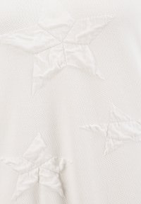 White fabric featuring embroidered stars in a slightly raised, textured pattern. The stars are irregularly shaped and vary in size.
