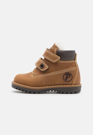 Brown toddler boot with two adjustable Velcro straps, black padded collar, fur lining, rugged sole, and circular logo on the side.