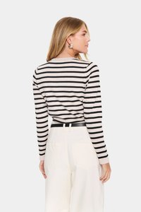 Beige ja musta triibuline pikkade varrukatega topp, valmistatud pehmest kangast. Omab ümarat kaelust ja kehakujulist disaini sirge hemiga.