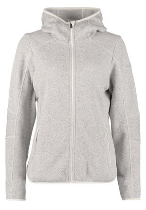 Persoon die een grijze hoodie met rits draagt, blauwe gescheurde spijkerbroek, grijze sneakers, met zwarte rugzakbanden op de schouders, lopend naar voren.