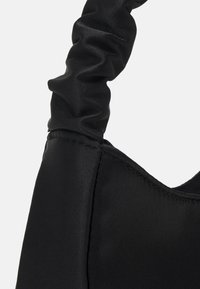 Black satin handbag with a ruched handle, featuring a smooth texture and a structured body, designed for a contemporary look.