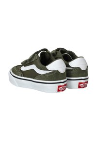 Zapatillas de ante verde y lona con detalles en blanco, correas de Velcro, suelas de goma blancas y una etiqueta de logo roja en el talón.