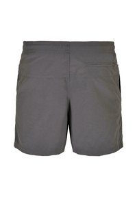 Grå shorts med elastisk midjebånd, en baklomme med glidelås og sidelommer. Stoffet virker lett med en subtil tekstur.