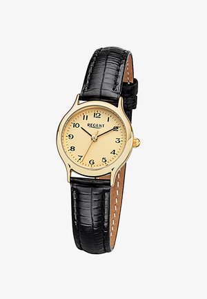 Montre ronde en or avec cadran beige, chiffres arabes noirs, trois aiguilles en or et bracelet en cuir noir avec coutures visibles.