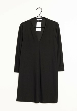 Black, long-sleeve dress with a V-neck, made of medium-weight fabric. Features a tag attached at the neck, hanging from a black hook.