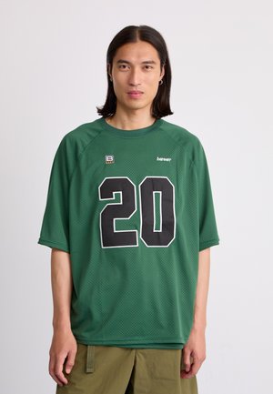 Green mesh jersey with black number '20' on the front, round neck, short sleeves, and small logo detail at the upper left.