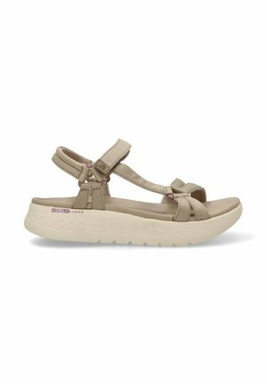 Sandalias beige con correas ajustables, una plantilla acolchada y una suela ligera con un patrón de agarre texturizado.