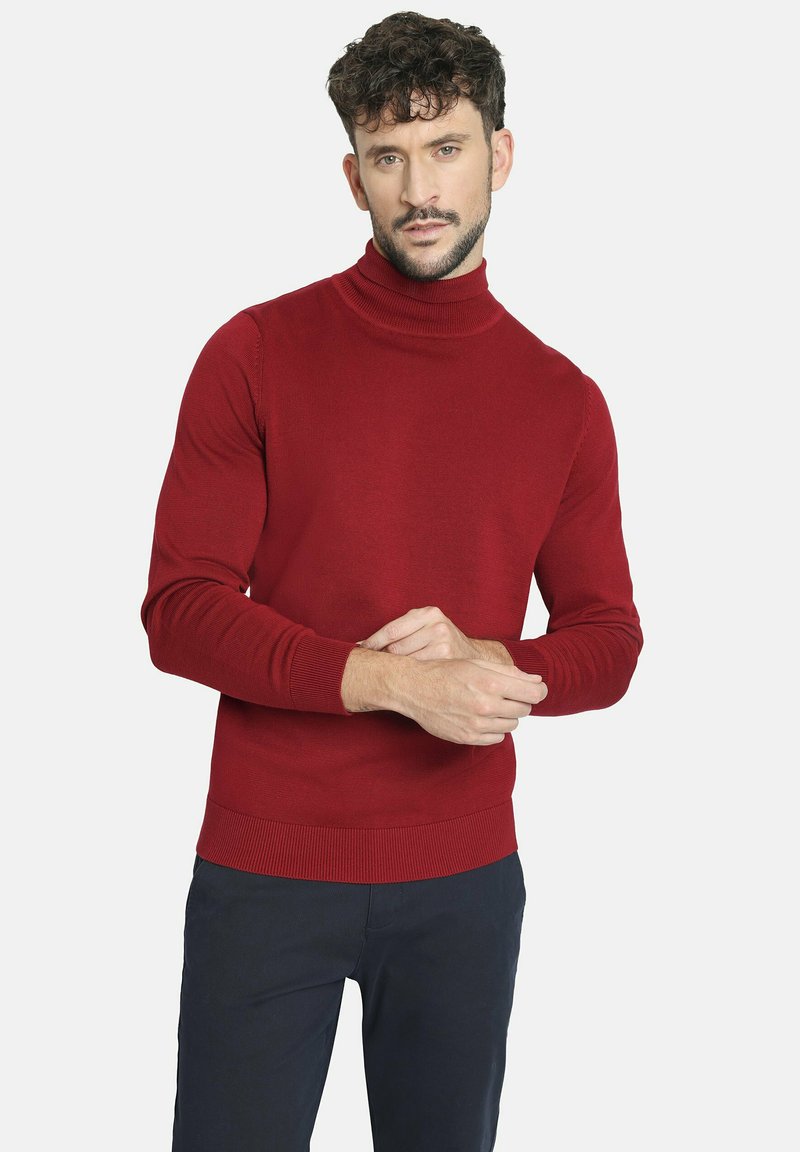 Jersey de cuello alto rojo con textura acanalada y mangas largas, que presenta una silueta ajustada y un diseño de color sólido.