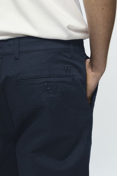 Shorts en coton bleu marine au toucher lisse, dotés d'une poche arrière avec fermeture à bouton et d'un logo brodé sur la ceinture.