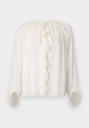 White, long-sleeved blouse with a ruffled neckline and cuffs. Soft, lightweight fabric with gathered detailing at the shoulders and sleeves.
