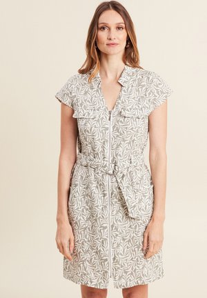 Lichtgewicht, korte mouwen jurk in beige met een bladerenpatroon, rits aan de voorkant, twee zakken en een ceintuur in de taille. Casual pasvorm.