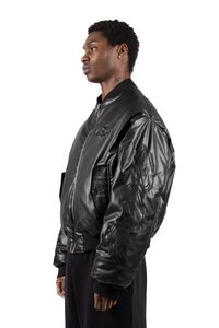Black leather bomber jacket with ribbed cuffs and hem, featuring embossed logo designs on the sleeves and a silver front zipper.