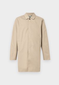 Μπεζ ελαφρύ παλτό με ίσια γραμμή, κλείσιμο με ένα κουμπί και πλαϊνές τσέπες. Κατασκευασμένο από λείο ύφασμα με μινιμαλιστικό σχέδιο.