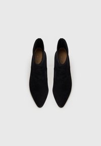 Black suede ankle boots with a pointed toe and smooth surface. Features minimalistic design and elasticated sides for easy wear.