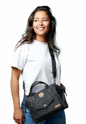 Schwarze Stoffhandtasche mit kurzem Griff und einem langen, verstellbaren Riemen, ausgestattet mit einer Frontklappen-Tasche, silbernen Beschlägen und Leder-Logo-Akzent.