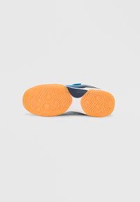 Εμφανίζεται η εξωτερική σόλα του αθλητικού παπουτσιού· διαθέτει πορτοκαλί ελαστική σόλα με μοτίβο για πρόσφυση, λευκή μεσαία σόλα και μπλε επάνω τμήμα με μπλε λεπτομέρειες.