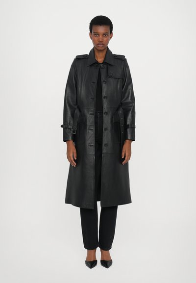Black leather trench coat with a belted waist, large button closures, and side pockets. Smooth texture, long sleeves, and knee-length design.