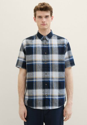 Short-sleeve plaid shirt featuring navy, gray, white, and blue colors. Button closure with a classic collar, lightweight fabric, and a relaxed fit.
