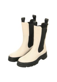 Beige Leder-Stiefeletten mit schwarzen elastischen Seitenteilen, Zuglaschen und klobigen schwarzen Sohlen, die ein schlankes, modernes Design aufweisen.