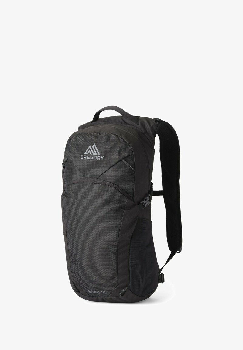 Black backpack with a textured fabric, featuring a top handle, padded straps, and a zippered compartment. Front logo reads "GREGORY."