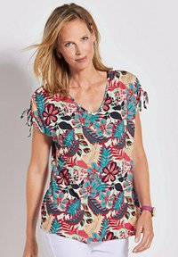 Korte mouwen top met bloemenprint, voorzien van een V-hals, kleurrijke patronen in rood, blauw en groen, met strikaccenten op de mouwen.
