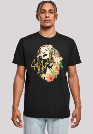 Schwarzes Baumwoll-T-Shirt mit einem floralen Grafikdesign in lebhaften Farben, das ein Gesicht umgeben von Blumen zeigt, mit gelben Textakzenten.