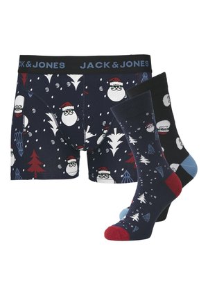 Boxers marins avec des motifs de Père Noël et des chaussettes ornées d'arbres de Noël, de flocons de neige et de motifs de fête dans des couleurs sombres et discrètes.