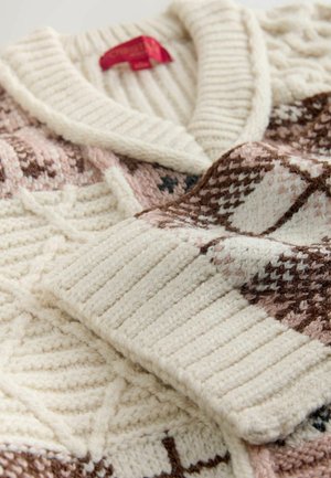 Knitted sweater in cream with a ribbed collar. Features geometric patterns in brown and blush, with a soft, textured finish.