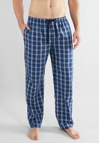 Heren loungebroeken van ruitpatroon in blauwtinten, met een elastische tailleband met trekkoord, zijzakken en een relaxed fit. Gemaakt van katoen.