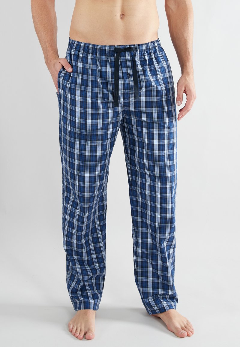 Heren loungebroeken van ruitpatroon in blauwtinten, met een elastische tailleband met trekkoord, zijzakken en een relaxed fit. Gemaakt van katoen.