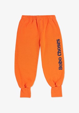 Pantalons de survêtement orange en coton avec des poignets et une taille élastiqués. Présente le logo "Bobo Choses" en bleu marine sur la cuisse gauche.