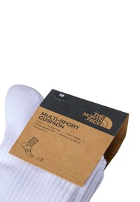 Multisport kussensokken in het wit, met ribbeltextuur. Verpakt met een bruine kartonnen label waarop het logo en de maatinformatie staat.