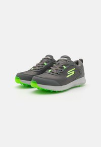 Gray athletic shoes with a mesh upper, green accents, textured sole, and cushioned midsole. Features laces and logo on the side.