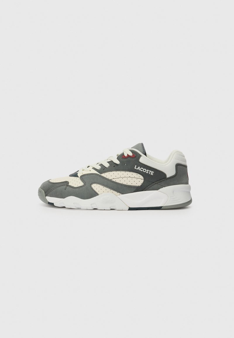 Gray and cream athletic sneaker with perforated side panels, white laces, and a white rubber sole. Features subtle red accents and logo.