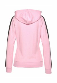 Felpa rosa con cappuccio e strisce nere sui lati. Tessuto morbido, design aderente e polsini e orlo a coste. La vista posterior mostra i dettagli della cucitura.