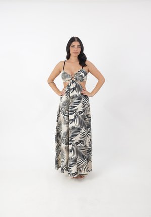 Vestido maxi en beige con estampado de hojas de palma negras. Presenta un diseño con nudo en la parte delantera, tirantes finos y una silueta fluida.