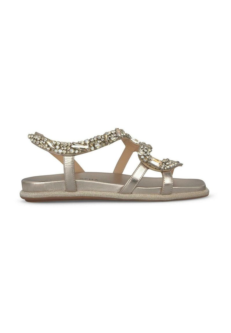 Sandali piatti in oro metallico con cinturini decorativi di perline e suola ammortizzata. Design aperto con diverse bande di supporto che attraversano il piede.