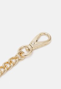 Gold metal clasp with a smooth finish, featuring a chain link design. Engraved with "VALENTINO" on the side for branding identification.