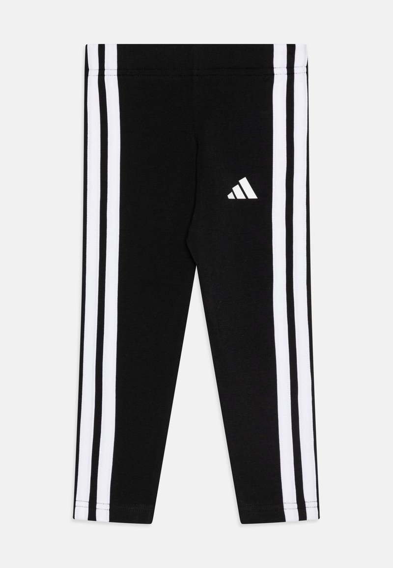 Leggings deportivos negros con tres rayas verticales blancas a lo largo de cada lado y un pequeño logotipo blanco de Adidas en el muslo izquierdo.