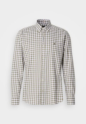 Brun og hvit rutete skjorte med knapper laget av bomull. Har spiss krage, lange ermer, og en liten logo på brystet.