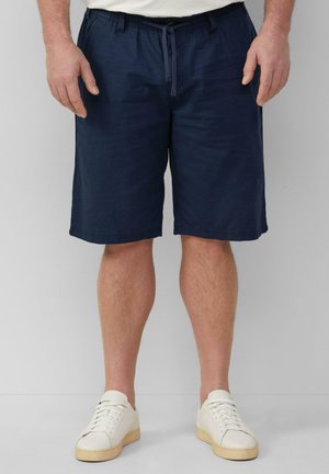 Shorts bleu marine en tissu tissé, dotés d'une taille élastique avec cordon de serrage, de poches latérales et d'une coupe droite qui arrive au niveau des genoux.