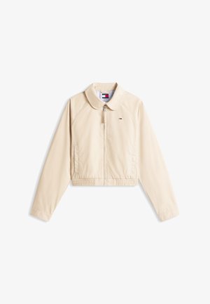 Chaqueta beige claro, de manga larga, con cremallera, cinturilla elástica, cuello puntiagudo, bolsillos laterales y un pequeño logo de Tommy Hilfiger en el pecho.