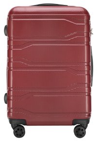 Valise rigide rouge avec surface texturée, design rainuré, poignée supérieure et quatre roues pivotantes pour la mobilité. Conçue pour la durabilité.